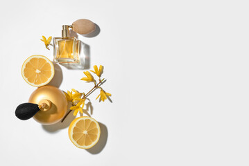 Bottles of fresh perfumes on light background, top view