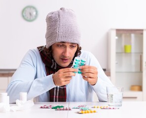 Young man suffering from flu at home