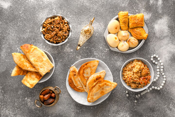 Traditional Eastern dishes with Aladdin lamp on grunge background