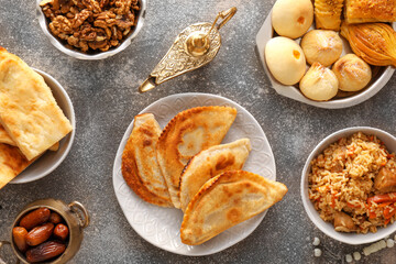 Traditional Eastern dishes with Aladdin lamp on grunge background