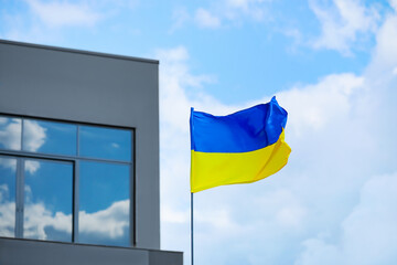 Big national flag of Ukraine on city street