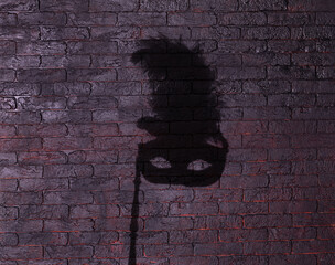 shadow of theatrical mask on black background