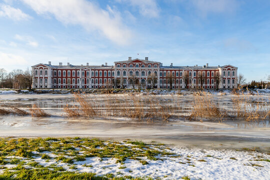 Beautiful red and white residence in the park on the river bank. Building in the city. Manor house on the river in winter. Palace in the park at Jelgava, Latvia, Europe.