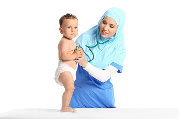 Muslim pediatrician examining baby boy on white background