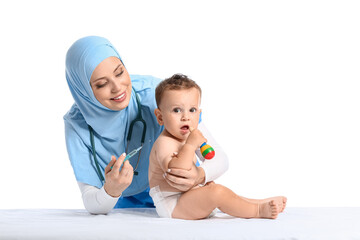 Muslim pediatrician vaccinating baby boy on white background