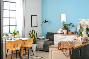 Interior of cozy kitchen with modern furniture and houseplants