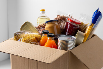 charity, support and concept - close up of food in donation box - obrazy, fototapety, plakaty