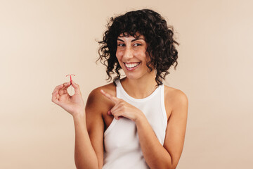 Woman holding the copper IUD in her hand