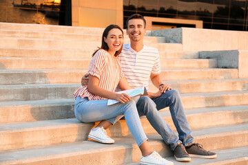 Couple of young tourists with map outdoors