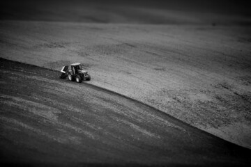 Grayscale of a tractor in an agricultural field in Moravia, Czech Republic