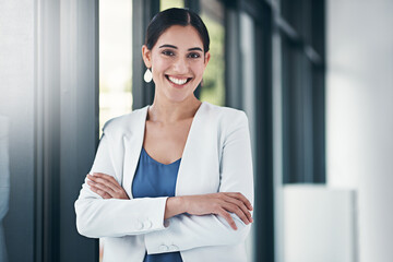 Shes the perfect blend of confidence and positivity. Portrait of a successful businesswoman standing with her arms folded in the office.