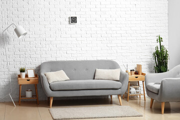Modern interior of room with sofa, armchair and tables