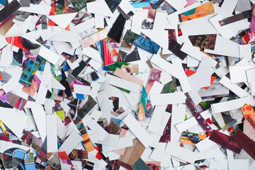 Lots of colorful sheets broken by a shredder. Broken cuts photos, destruction of memories background