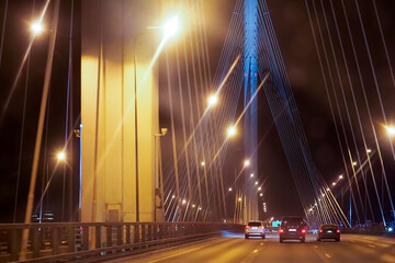 Obraz na płótnie Canvas Traffic on cable-stayed bridge in St. Petersburg at night. Western High-speed Diameter. Modern transport highway