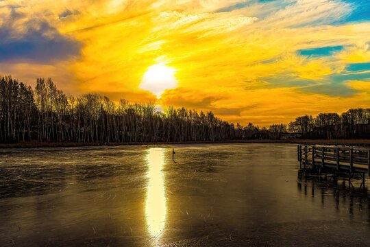 Sunset over the frozen pond 