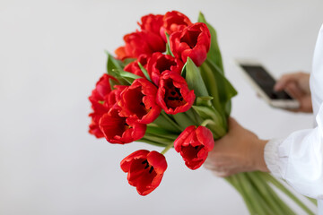bouquet of red tulips in hands