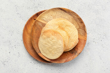 Wooden plates with Jewish flatbread matza for Passover on light background