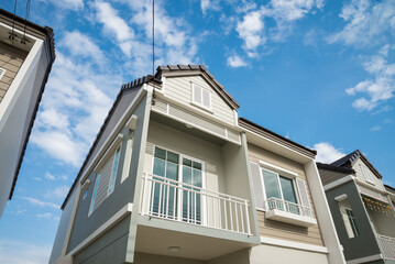 New house for sale with blue sky background. Real estate property, home loan and banking concept.