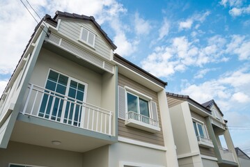 New house for sale with blue sky background. Real estate property, home loan and banking concept.
