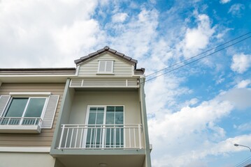 New house for sale with blue sky background. Real estate property, home loan and banking concept.