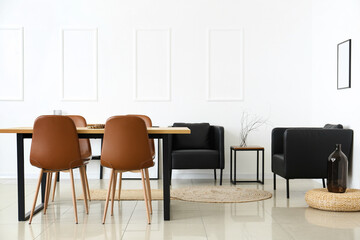Interior of modern dining room with table and black armchairs