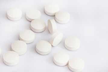 white medicine tablets or pills on white background