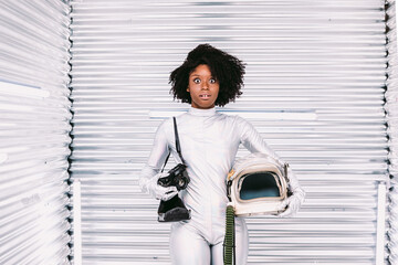 Astonished black woman in astronaut costume
