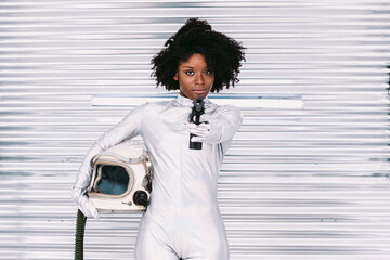Black cosmonaut with gun in spaceship