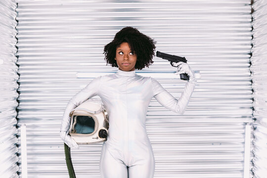 Black Astronaut Pointing Gun At Head