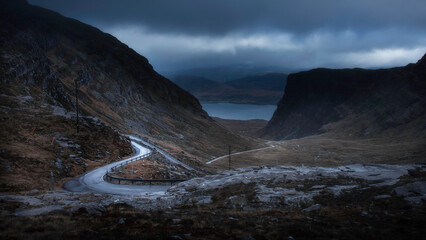 Moody sky over Applecross pass in Scotland. Beautiful view on NC500 road trip. Dark and moody landscape scenery.