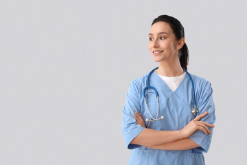 Portrait of female doctor on grey background