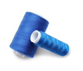 Blue sewing thread spools on white background