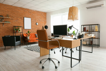 Fototapeta na wymiar Stylish interior of office with comfortable workplaces