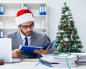 Young businessman celebrating christmas in the office