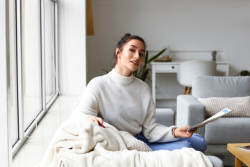 Beautiful young woman resting on couch at home