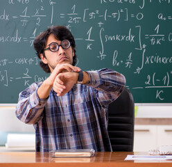 Funny male math teacher in the classroom