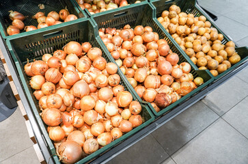 Fresh onion of new harvest in the plastic boxes