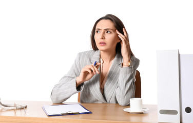 Young secretary at table on white background