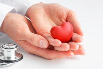 Doctor hands holding red heart. Cardiology, heart health and care, Health Day concept