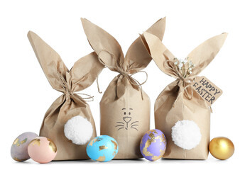 Creative Easter bunny gift bags with beautiful eggs on white background