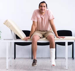 Young injured man waiting for his turn in hospital hall