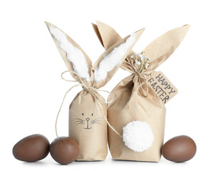 Easter bunny gift bags and chocolate eggs isolated on white background