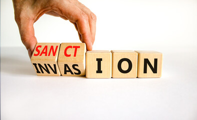 Sanction against invasion symbol. Businessman turns cubes and changes the concept word Invasion to Sanction. Beautiful white background. Business sanction against invasion concept. Copy space. - obrazy, fototapety, plakaty