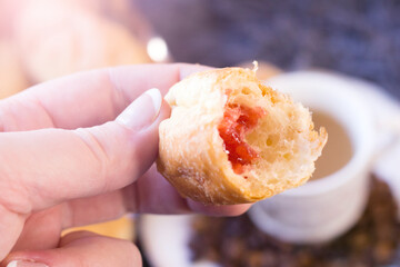 Croissant with pink jam so close