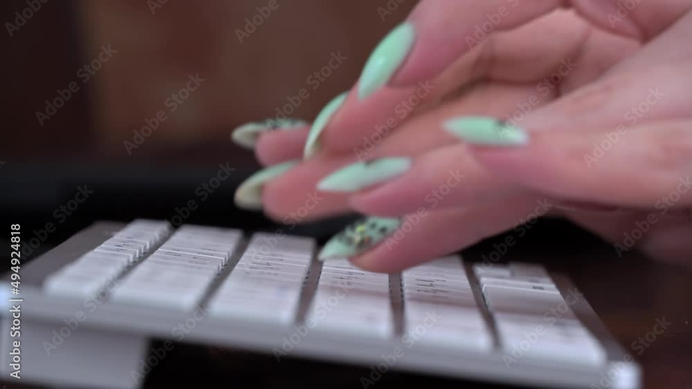 Poster business woman's fingers are typing on the keyboard of a white laptop. the hands of a young girl are