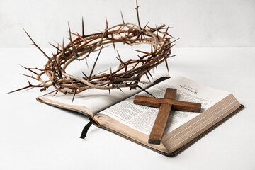 Fototapeta na wymiar Crown of thorns with Holy Bible and cross on white background