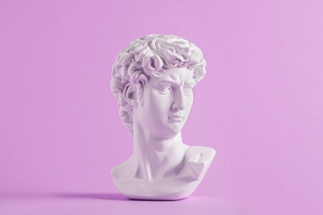 Ancient statue is head of David on purple background. - obrazy, fototapety, plakaty
