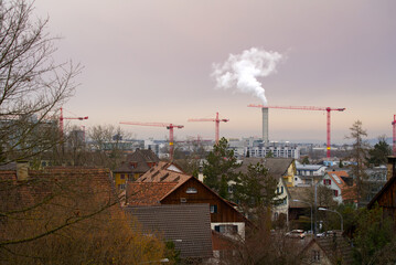 Skyline of Zürich Schwamendingen and orange sky background because of Sahara dust in the sky on a cloudy spring late afternoon. Photo taken March 15th, 2022, Zurich, Switzerland.