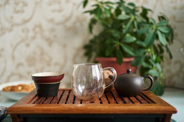 teapot and bowls prepared for the tea ceremony on a stand made of bamboo