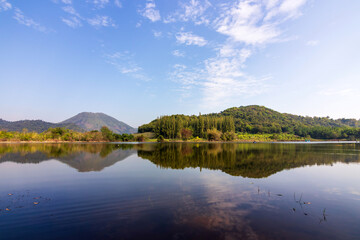 Tha Khoei reservoir in Ratchaburi, Thailand. Beautiful landscape of lake and range of mountain with pine forest. 